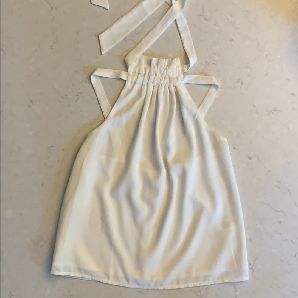 This is a white tank with a cool strappy back!